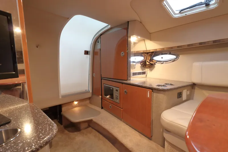 Slide: The Image of Interior of 2006 Formula 330 Sun Sport boat with kitchenette and seating area. - 20
