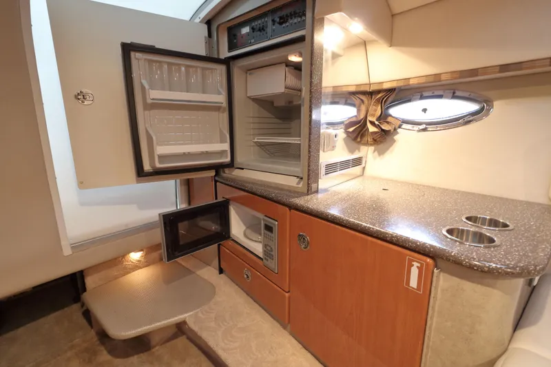 Slide: The Image of 2006 Formula 330 Sun Sport interior kitchen with fridge, microwave, and countertop. - 21