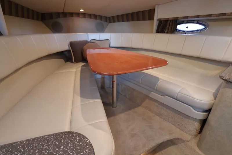 Slide: The Image of Interior of 2006 Formula 330 Sun Sport boat with plush seating and wooden table. - 23