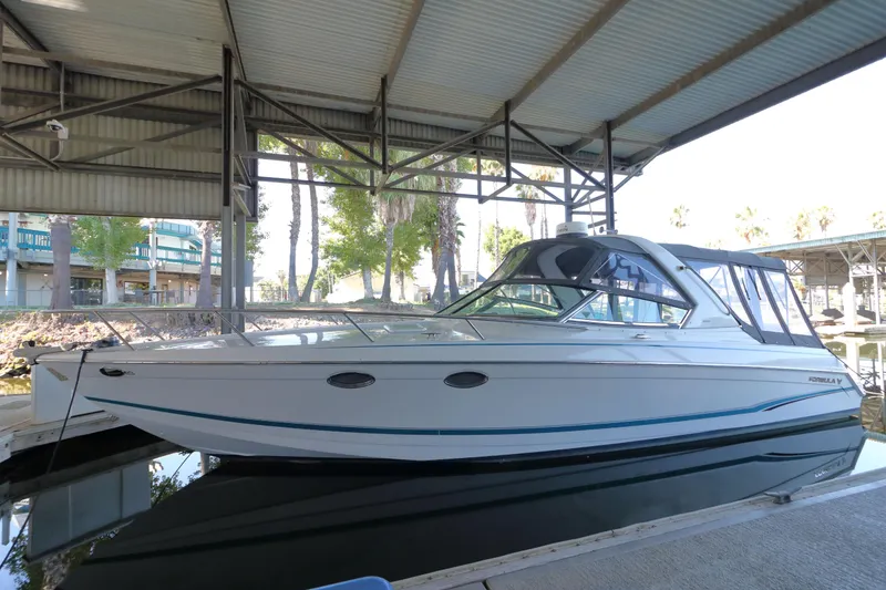 Slide: The Image of 2006 Formula 330 Sun Sport boat docked under a covered marina. - 3