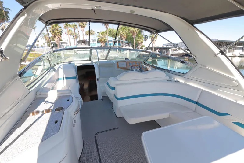 Slide: The Image of 2006 Formula 330 Sun Sport boat interior with seating and helm, docked at marina. - 8