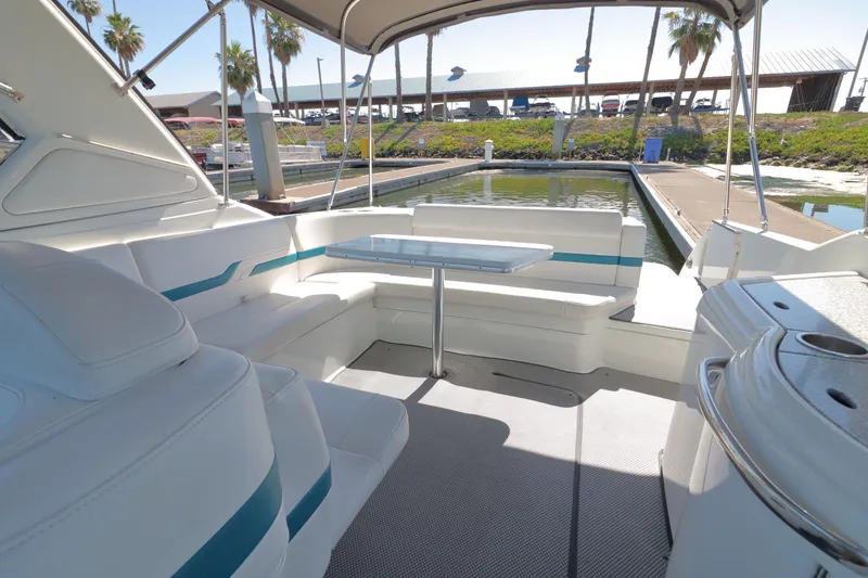 Slide: The Image of 2006 Formula 330 Sun Sport boat interior with seating and table at a marina. - 9