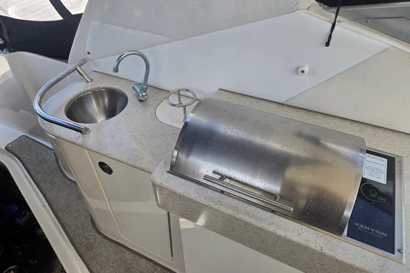 Slide: The Image of Outdoor kitchenette on 2010 Sea Ray Sundancer 330 with sink and grill. - 13