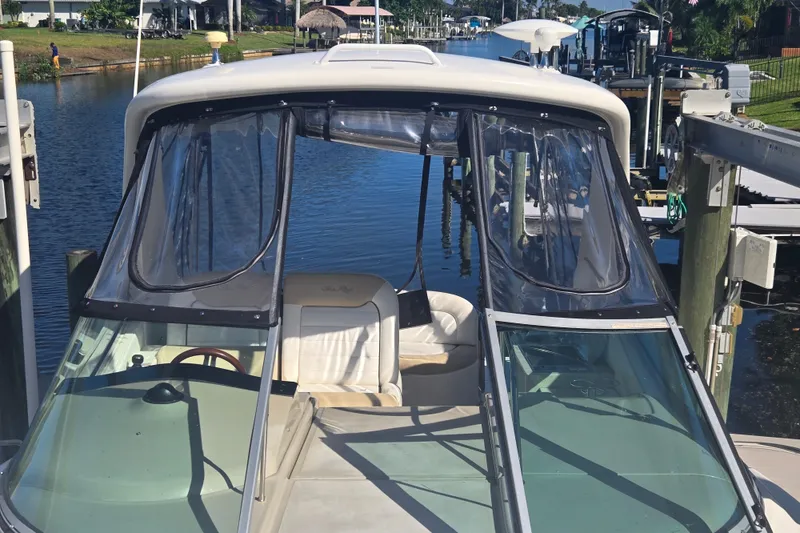 Slide: The Image of 2010 Sea Ray Sundancer 330 docked by a serene waterfront. - 16