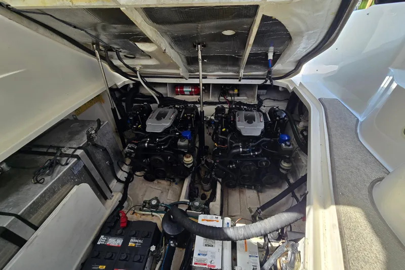 Slide: The Image of Engine compartment of a 2010 Sea Ray Sundancer 330, showcasing dual engines and mechanical components. - 18