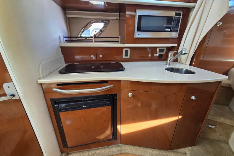 Slide: The Image of Compact kitchen area in a 2010 Sea Ray Sundancer 330 yacht with microwave and sink. - 22