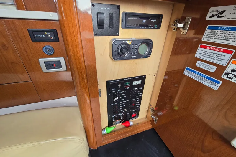 Slide: The Image of Control panel inside a 2010 Sea Ray Sundancer 330 boat, featuring various switches and gauges. - 25