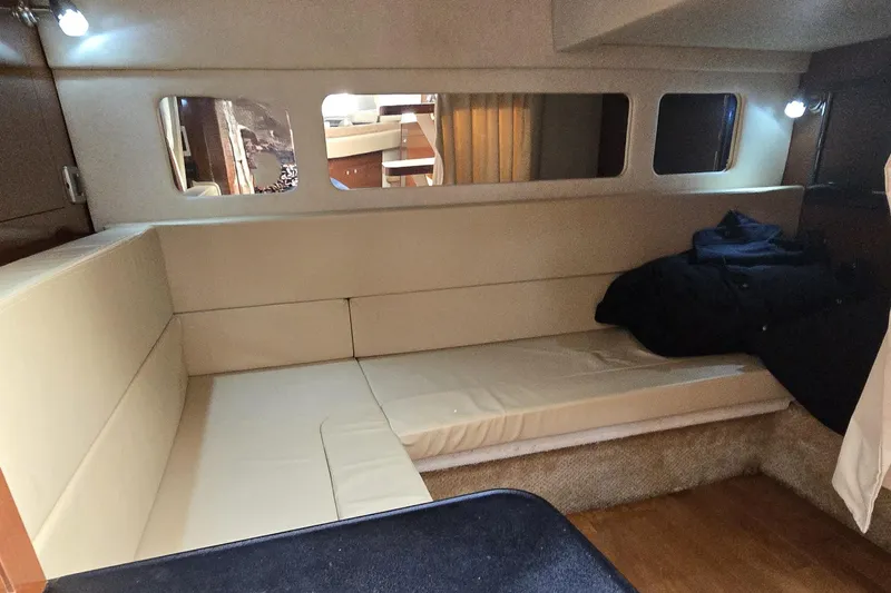 Slide: The Image of Interior cabin of 2010 Sea Ray Sundancer 330 with beige seating and ambient lighting. - 26