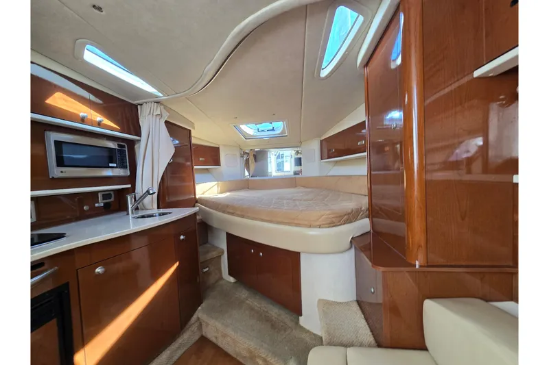 Slide: The Image of Luxurious interior of 2010 Sea Ray Sundancer 330 yacht with wood cabinetry and cozy sleeping area. - 3