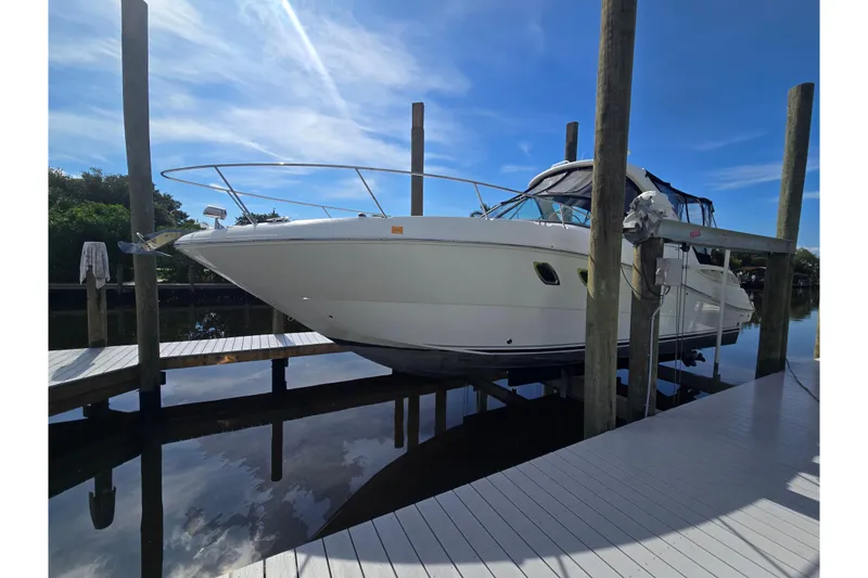 Slide: The Image of 2010 Sea Ray Sundancer 330 yacht docked, showcasing sleek design and modern features. - 30