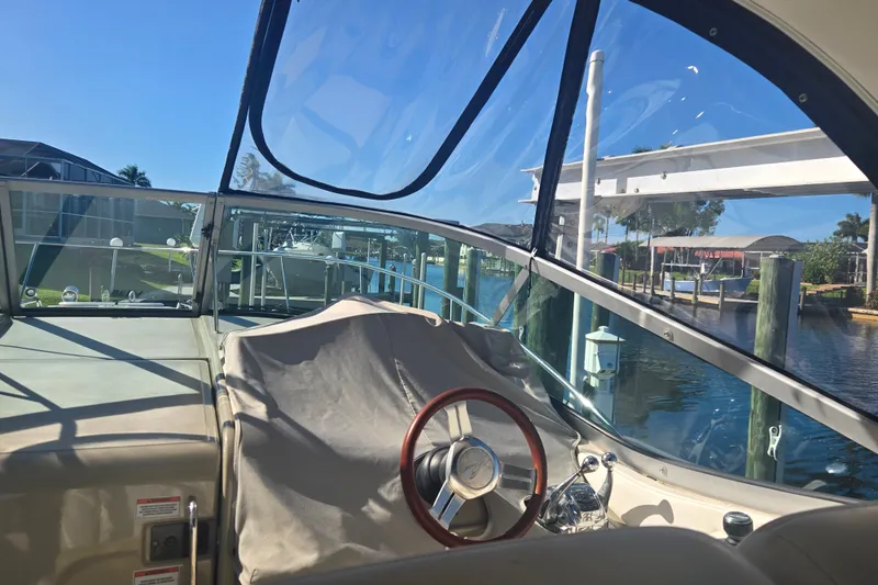 Slide: The Image of Cockpit view of a 2010 Sea Ray Sundancer 330 yacht docked by a sunny marina. - 4
