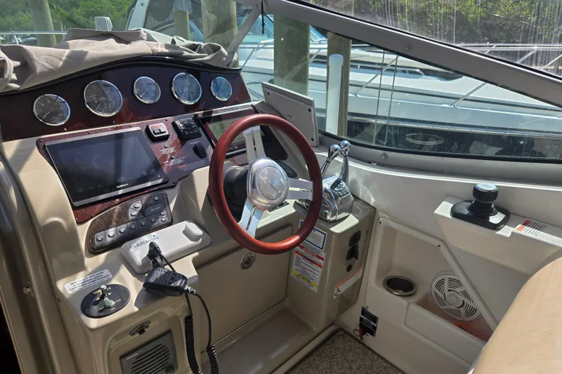 Slide: The Image of Cockpit of 2010 Sea Ray Sundancer 330 with steering wheel and navigation controls. - 5