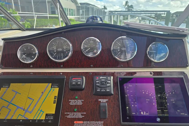Slide: The Image of Dashboard of a 2010 Sea Ray Sundancer 330 with navigation and control instruments. - 6