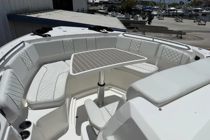 Slide: The Image of Luxurious seating area on 2022 Pursuit S 358 Sport boat with elegant table setup. - 13