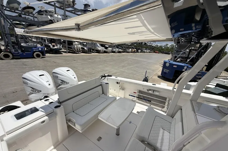 Slide: The Image of 2022 Pursuit S 358 Sport boat with Yamaha engines, docked at a marina. - 16