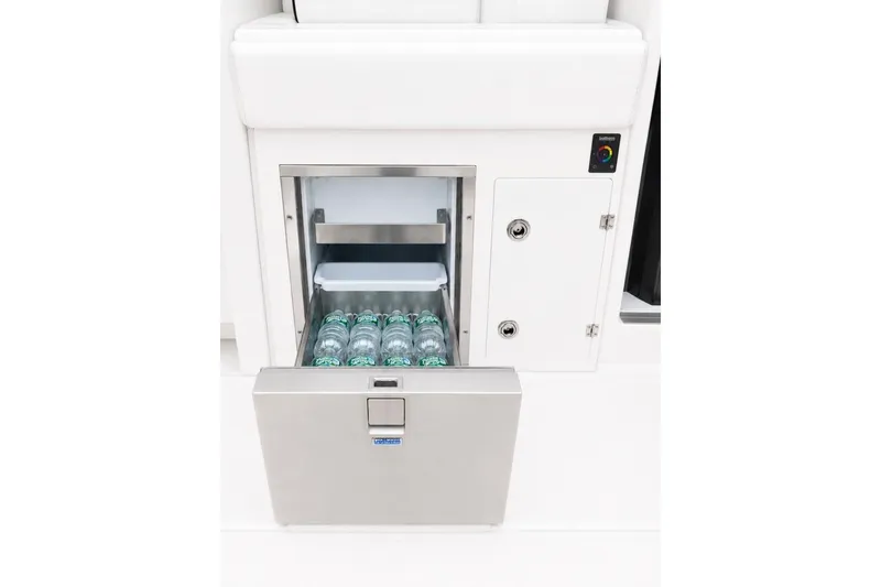Slide: The Image of Built-in cooler on 2022 Pursuit S 358 Sport boat, stocked with bottled drinks. - 19