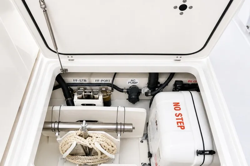 Slide: The Image of 2022 Pursuit S 358 Sport boat compartment with equipment and "No Step" warning. - 21