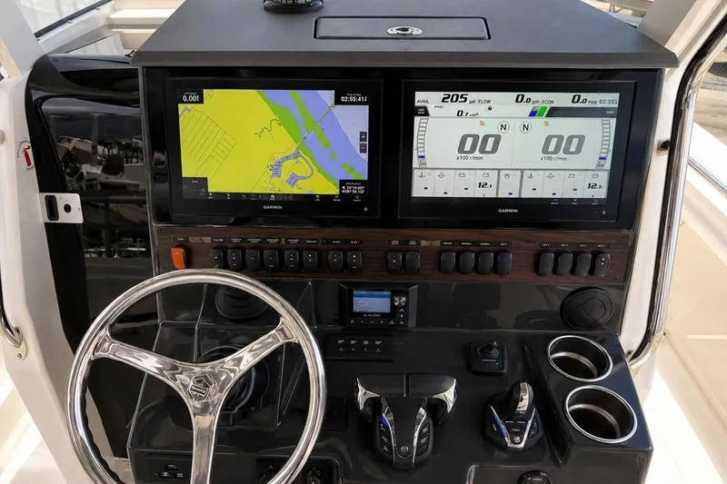 Slide: The Image of 2022 Pursuit S 358 Sport boat dashboard with dual Garmin displays and controls. - 5