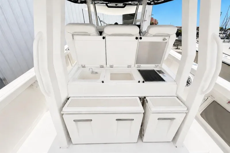 Slide: The Image of 2022 Pursuit S 358 Sport boat interior with storage compartments and seating. - 6
