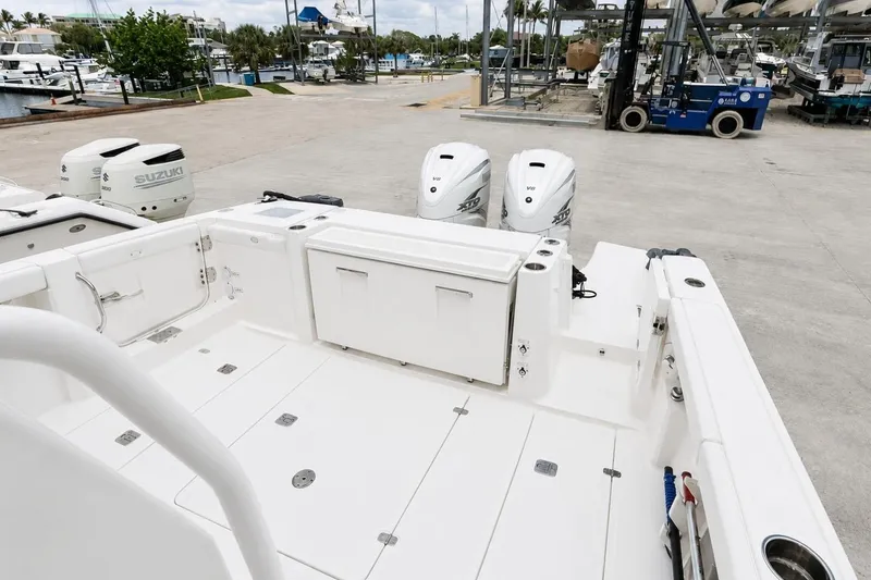 Slide: The Image of 2022 Pursuit S 358 Sport boat with dual Suzuki outboard engines at a marina. - 7