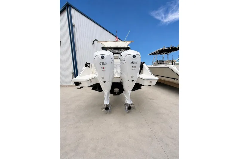 Slide: The Image of 2022 Pursuit S 358 Sport boat with dual 425 V8 engines, docked outdoors. - 8