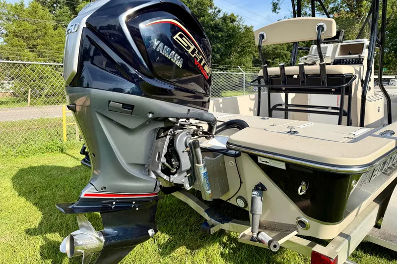 Slide: The Image of 2015 Blazer Bay 2200 Fisherman boat with Yamaha outboard motor, parked on grass. - 3