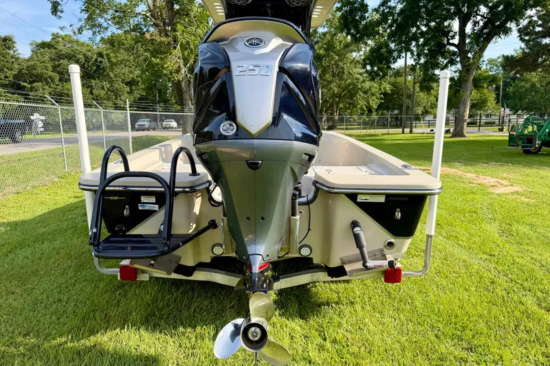 Slide: The Image of 2015 Blazer Bay 2200 Fisherman boat with powerful outboard motor on grassy area. - 4