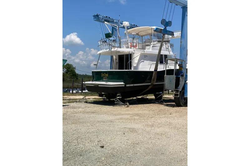 Slide: The Image of 2003 Mainship 390 Trawler on dry dock under clear blue sky. - 14