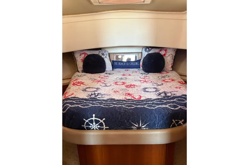 Slide: The Image of Cozy cabin bedroom in 2003 Mainship 390 Trawler with nautical-themed bedding. - 16