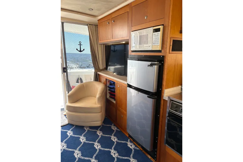 Slide: The Image of Interior of 2003 Mainship 390 Trawler with modern kitchen and cozy seating area. - 18