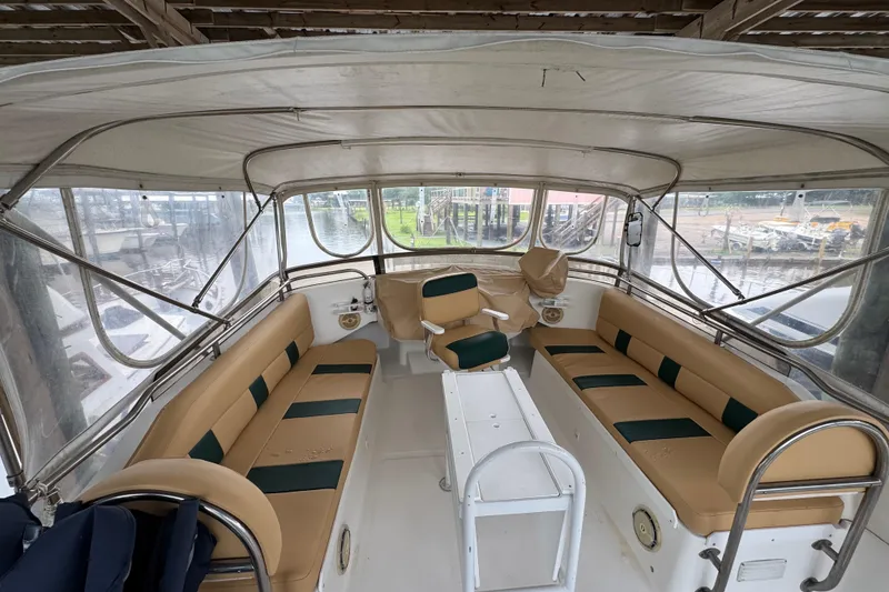 Slide: The Image of 2003 Mainship 390 Trawler interior with beige seating and panoramic windows. - 6