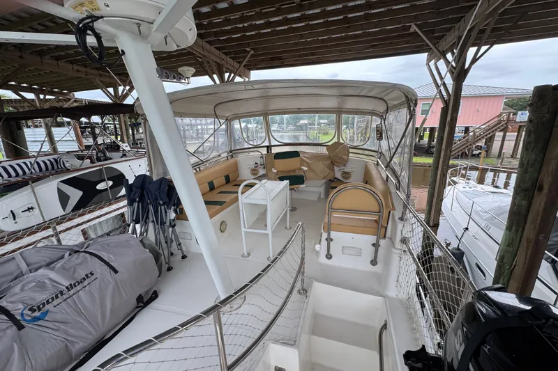 Slide: The Image of 2003 Mainship 390 Trawler interior with seating and covered deck area. - 7