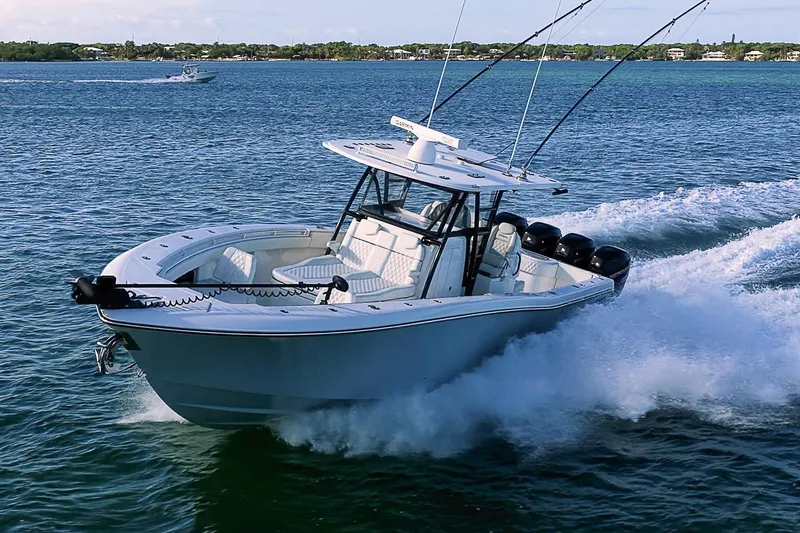 Slide: The Image of 2022 Invincible 39 Open Fisherman cruising on open water, showcasing sleek design and powerful engines. - 29