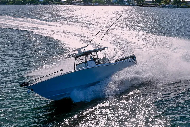 Slide: The Image of 2022 Invincible 39 Open Fisherman speeding on water, creating a dynamic wake. - 38