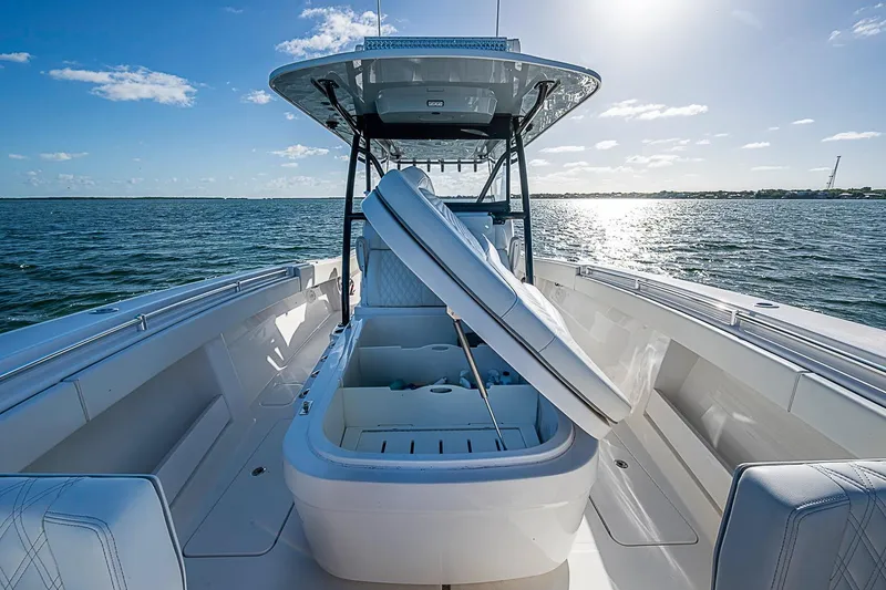 Slide: The Image of 2022 Invincible 39 Open Fisherman boat on water, open storage compartment, sunny day. - 52