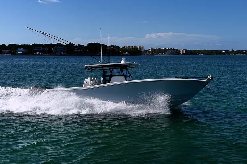 Slide: The Image of 2022 Invincible 39 Open Fisherman boat cruising on clear blue water. - 24