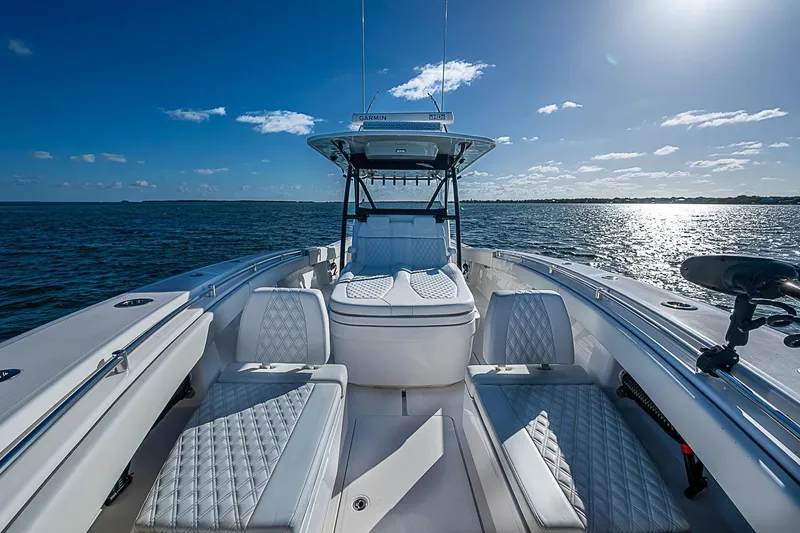 Slide: The Image of 2022 Invincible 39 Open Fisherman boat on open water, featuring luxurious seating and clear skies. - 49