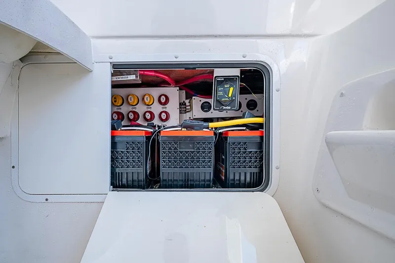 Slide: The Image of Electrical compartment of 2022 Invincible 39 Open Fisherman boat, showcasing batteries and control panel. - 71