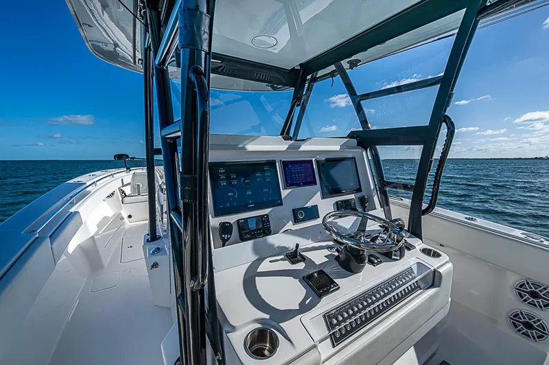 Slide: The Image of 2022 Invincible 39 Open Fisherman boat dashboard with ocean view and clear blue sky. - 74