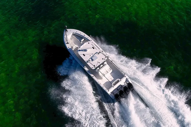 Slide: The Image of 2022 Invincible 39 Open Fisherman speeding on clear green waters. - 34