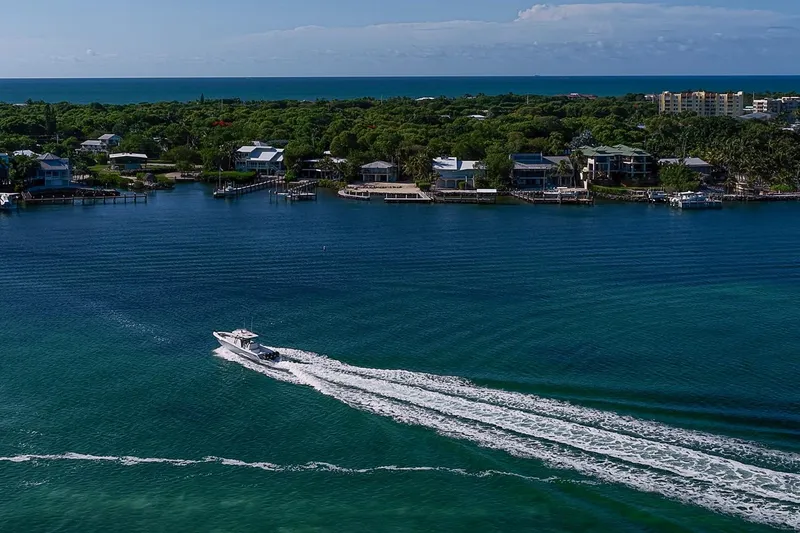 Slide: The Image of 2022 Invincible 39 Open Fisherman cruising on a scenic coastal waterway. - 41