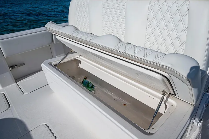 Slide: The Image of 2022 Invincible 39 Open Fisherman boat with open storage compartment and white seating. - 60