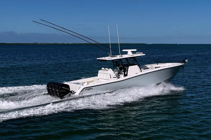 Slide: The Image of 2022 Invincible 39 Open Fisherman boat cruising on open water, equipped with multiple outboard engines. - 22