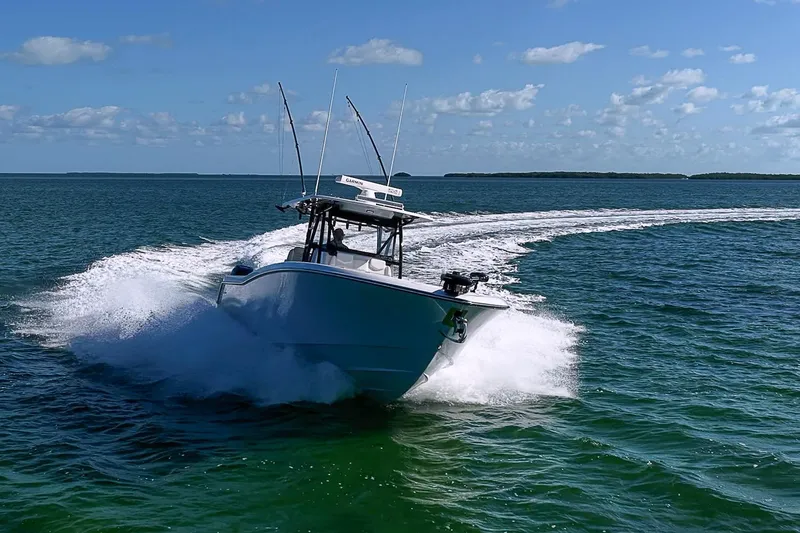 Slide: The Image of 2022 Invincible 39 Open Fisherman speeding on open water, creating a dynamic wake. - 27