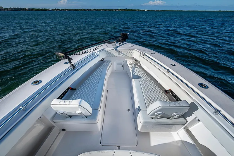 Slide: The Image of 2022 Invincible 39 Open Fisherman boat interior with cushioned seating on open water. - 44