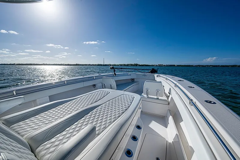 Slide: The Image of 2022 Invincible 39 Open Fisherman boat on calm water under clear blue sky. - 20
