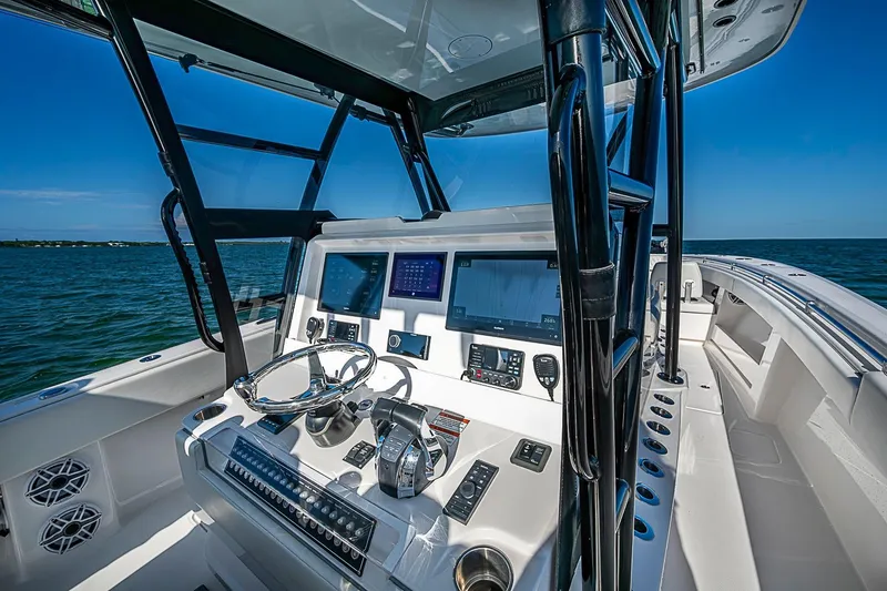 Slide: The Image of 2022 Invincible 39 Open Fisherman boat cockpit with advanced navigation systems and ocean view. - 72