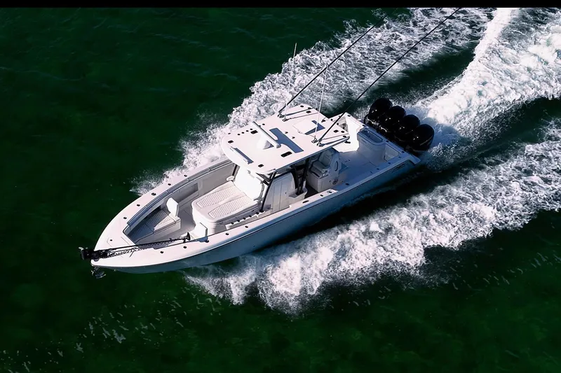 Slide: The Image of 2022 Invincible 39 Open Fisherman boat cruising on clear green water. - 32