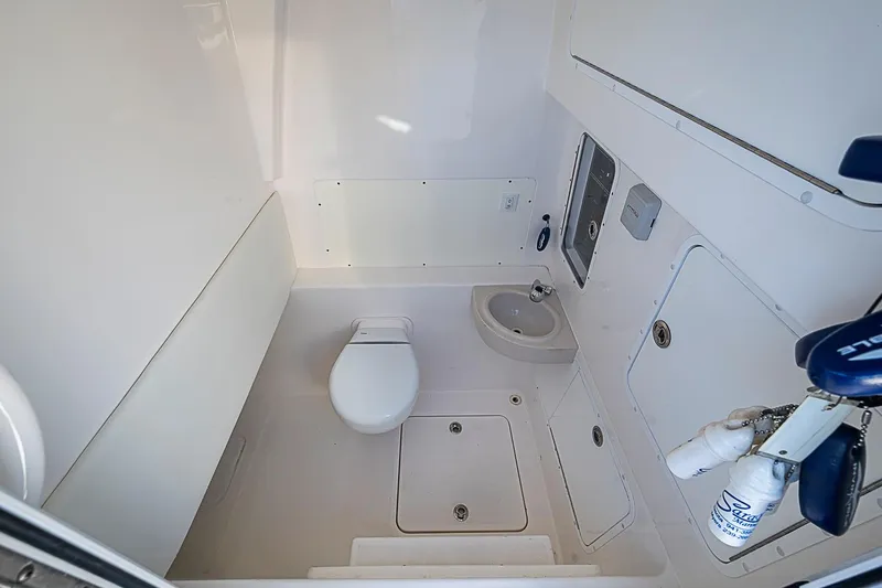 Slide: The Image of Interior of 2022 Invincible 39 Open Fisherman boat bathroom with toilet and sink. - 67