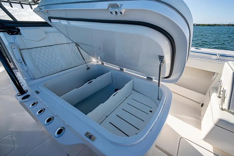 Slide: The Image of Open storage compartment on 2022 Invincible 39 Open Fisherman boat, with rod holders. - 53